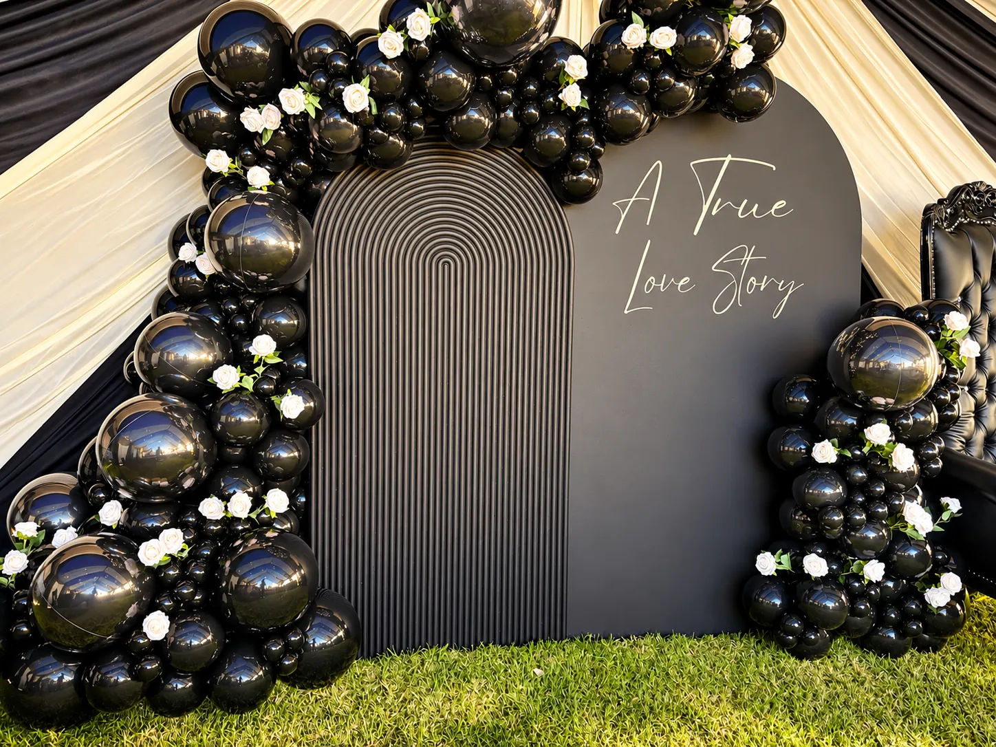 A True Love Story black arch backdrop with balloons